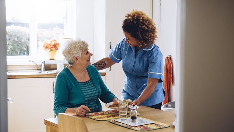 An Elderly Woman with Her Carer at Home. 